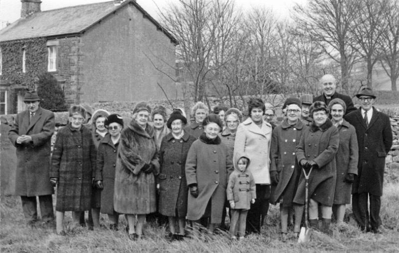 Baptist Chapel tree planting - 1974.JPG - Tree planting in the Baptist Chapel grounds in 1974. From left to right: Bill Jackson, Mrs Pye, Anon, Not known, Miss Dugdale,Mrs J.Dodgeson, Mrs H.Popay, Mrs A.Ward, Mrs Rene Proctor, Mrs Bert Wilson, Mrs Irene Stacey, Mrs Greaves, Mrs Irene Haw, Miss P.Smith, Miss H.Crinan, Miss Mgt Crinan, Mrs M.Bowker ( President WI ), Rev Glynn Jones (vicar), Mrs N.Robinson, Joe Parker. The young person in front is Jackie Hawe.  ( Does anyone know who the unidentified ladies are?  ) 